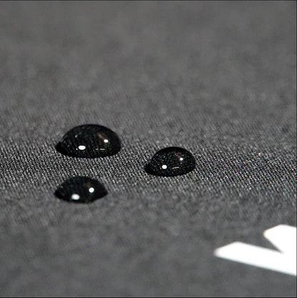 Close-up of black textured surface with water droplets highlighting rugged material for edgy streetwear mousepad.